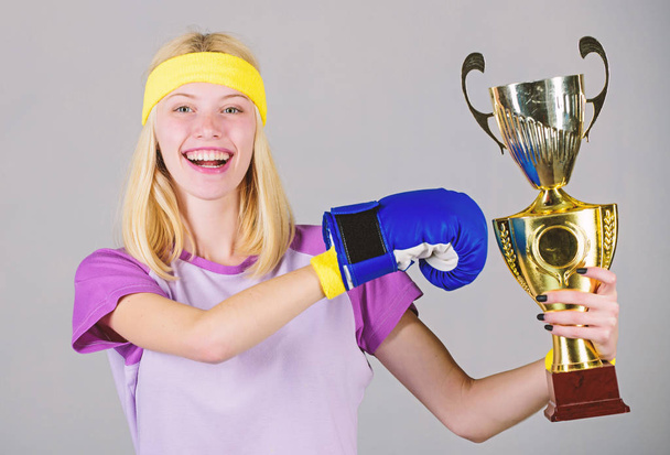 Celebrate victory. Boxing champion. Athletic girl boxing glove and golden goblet. Woman wear sport outfit. Girl cheerful boxer winner. Boxing is my hobby. Success in boxing. Sport achievement - Foto, Bild