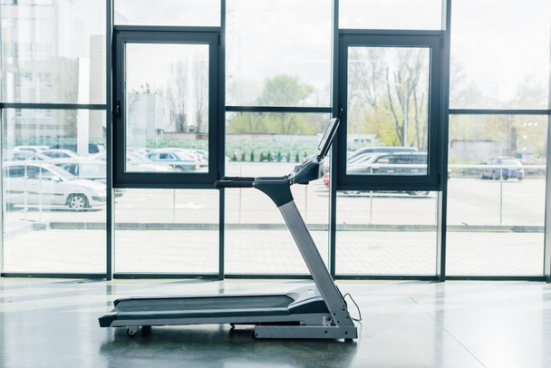 modern treadmill near windows at sports center - Foto, imagen