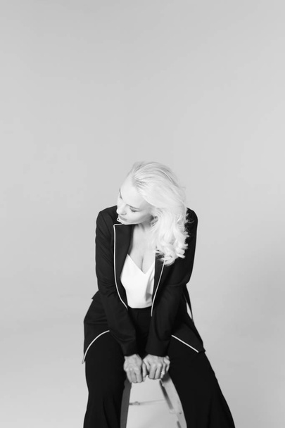 Portrait of a blond woman in a black dress - Фото, зображення