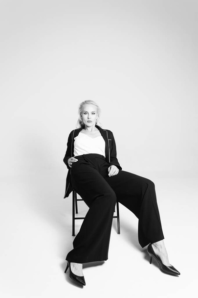 Portrait of a blond woman in a black dress - Fotoğraf, Görsel