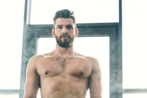 handsome bearded shirtless man in gym with smoke - Zdjęcie, obraz