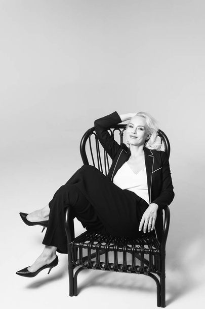 Portrait of a blond woman in a black dress - Foto, Imagen
