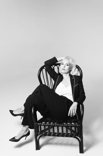 Portrait of a blond woman in a black dress - Foto, imagen