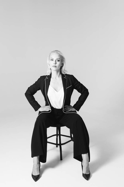 Portrait of a blond woman in a black dress - Fotografie, Obrázek