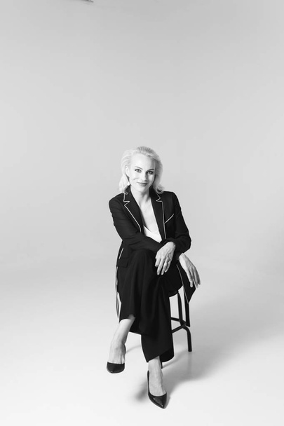 Portrait of a blond woman in a black dress - Valokuva, kuva