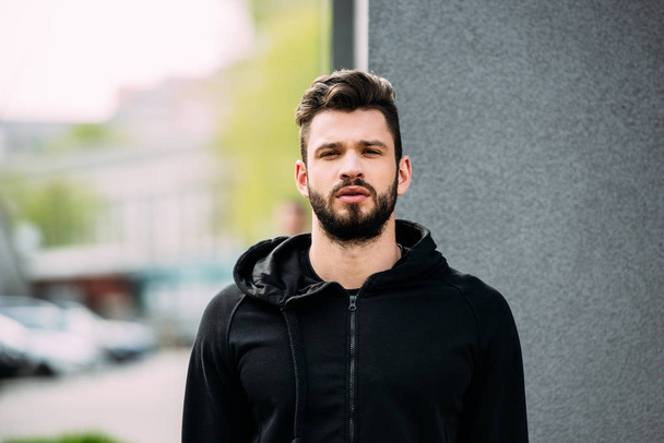 handsome bearded man in sportswear looking at camera - Photo, Image