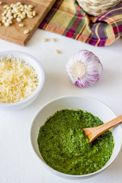 Pesto sauce and ingedients on a white background. Italian cuisine. Vegetarian food. The diet. - Foto, Imagen
