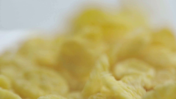 selective focus of tasty and sweet cornflakes falling into glass bowl - Materiał filmowy, wideo