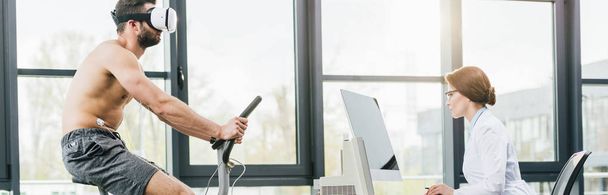 panoramic shot of sportsman in vr headset running on treadmill near doctor during endurance test in gym - Valokuva, kuva