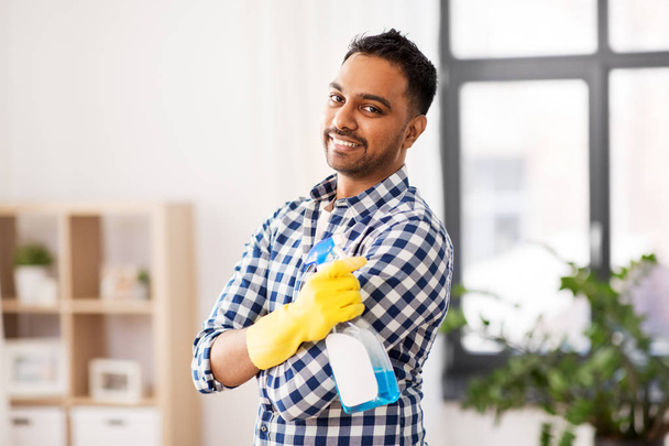 smiling indian man with detergent cleaning at home - Foto, Imagem