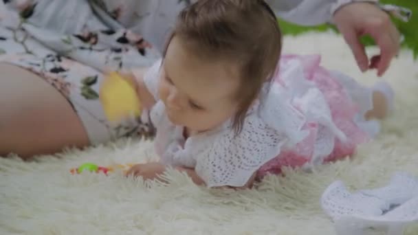 Happy mother playing with baby on bedspread. - Footage, Video