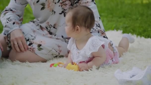 Happy mother playing with baby on bedspread. - Footage, Video