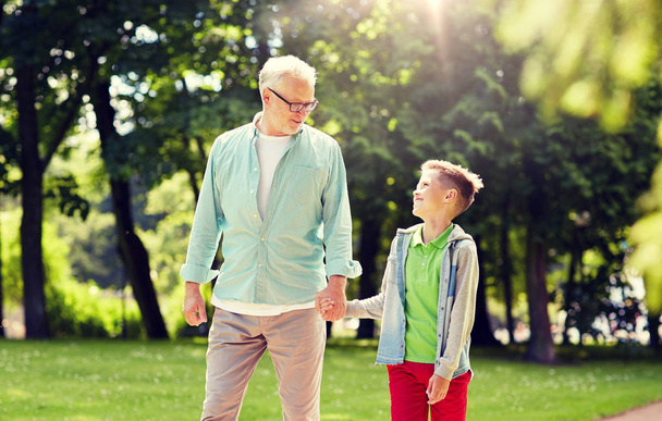 grandfather and grandson walking at summer park - Zdjęcie, obraz