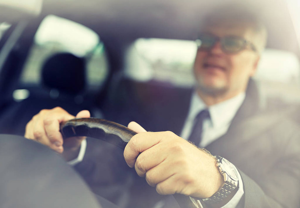 senior businessman hands driving car - 写真・画像