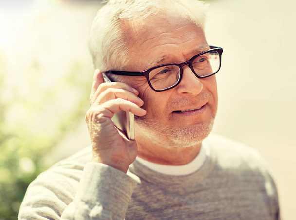 happy senior man calling on smartphone in city - Photo, Image