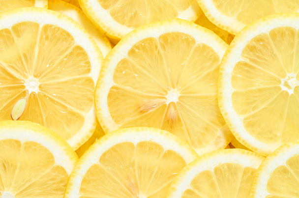 background of heap fresh yellow lemon slices. pattern for your design - Фото, изображение