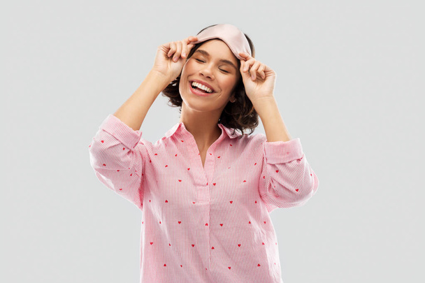 happy young woman in pajama and eye sleeping mask - Photo, image
