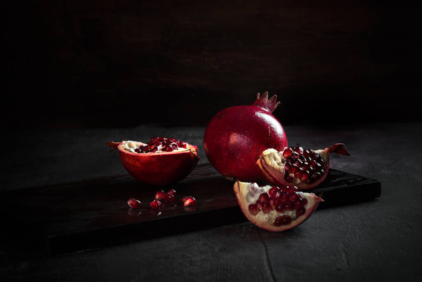 pomegranates and pears with other fruit bodegon with classic light on wood - Foto, Bild