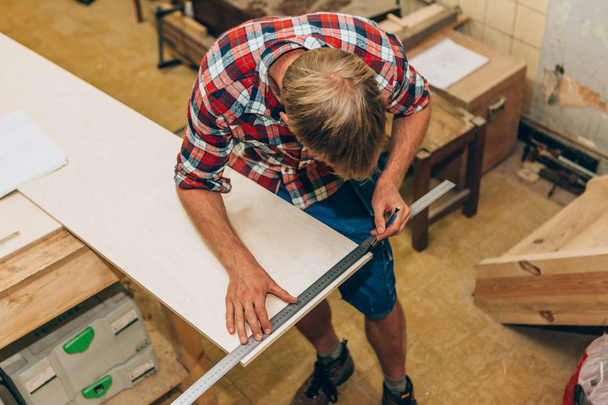 carpenter at work in his workshop - Photo, Image