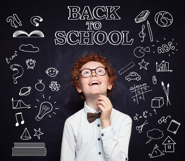 Back to school. Happy child student in classroom on chalkboard  - Fotó, kép