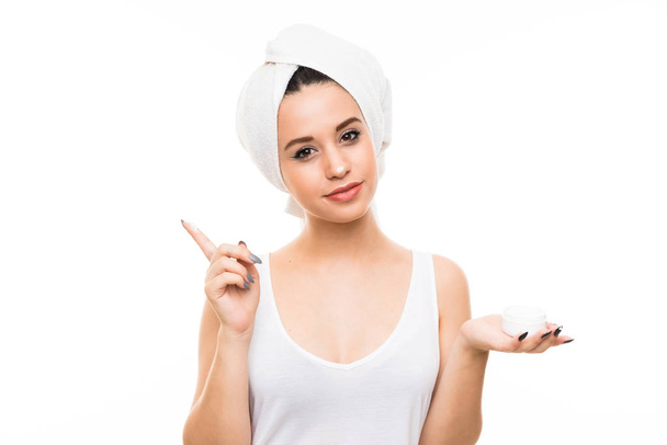 Young woman over isolated white background with moisturizer - Φωτογραφία, εικόνα