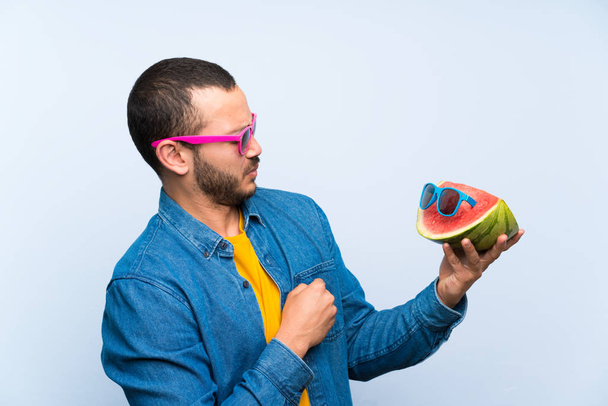 Colombian man holding a watermelon with sunglasses - Photo, Image