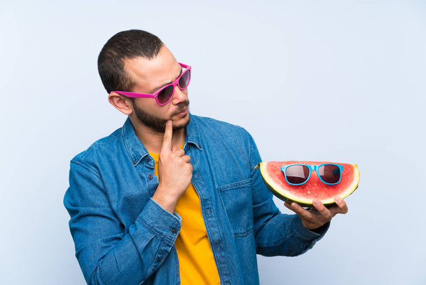 Colombian man holding a watermelon with sunglasses - Foto, afbeelding