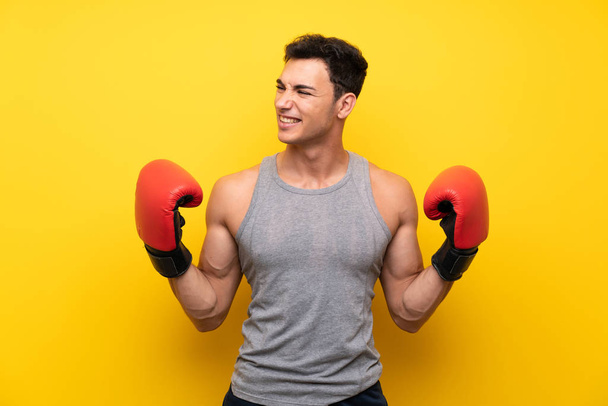 Handsome sport man over isolated background with boxing gloves - Photo, Image