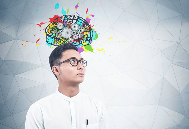 Serious Asian man, brain with gears - Photo, Image