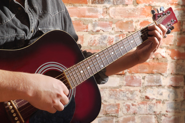 Playing on acoustic guitar - Фото, изображение