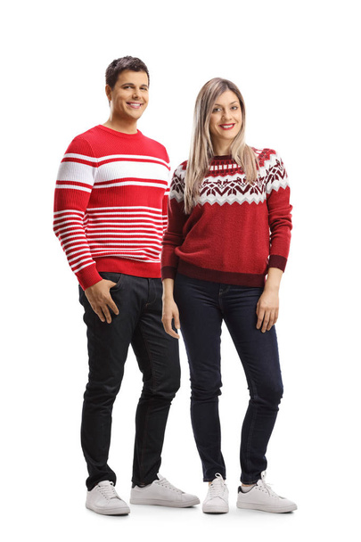 Young male and female wearing christmas red sweaters and posing  - Fotoğraf, Görsel