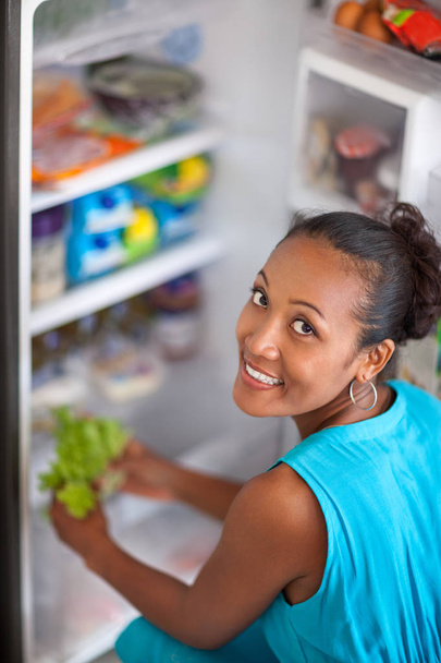 Young woman front open fridge - Foto, imagen
