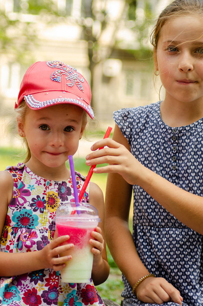 hermanas bebiendo cóctel o limonada en el parque
  - Foto, Imagen