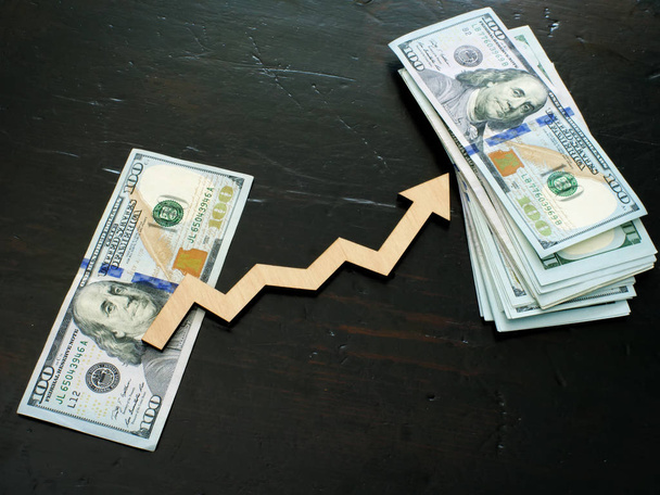 Finance success and investment concept. Stack of money and arrow. - 写真・画像