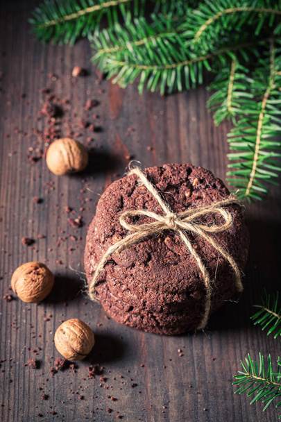 Top view of chocolate cookies with nuts and spruce - Fotografie, Obrázek