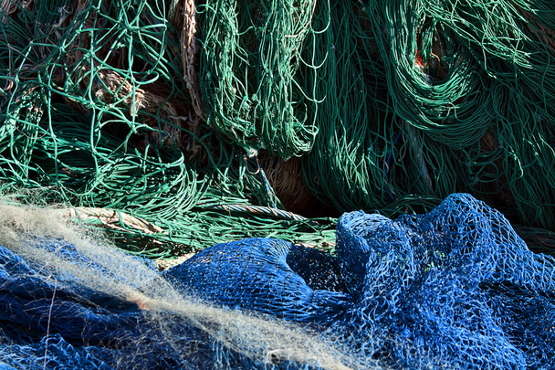 Blaue und grüne Fischernetze im Hafen - Foto, Bild