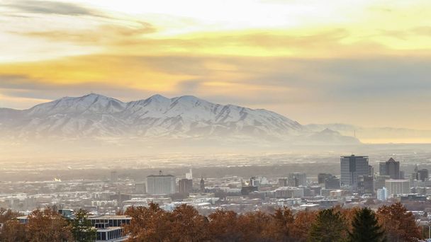 Panorama Panorama of downtown Salt Lake City against mountain and cloudy sky at sunset - Photo, Image