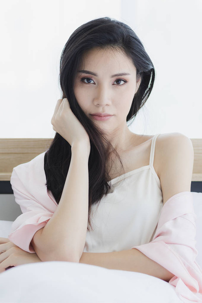  Asian woman model sitting and posing on bed - Φωτογραφία, εικόνα