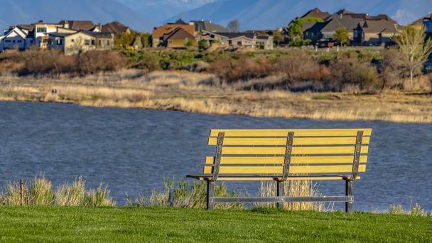 Panorama Bench with a scenic view of lake and snow capped mountain against blue sky - Photo, Image