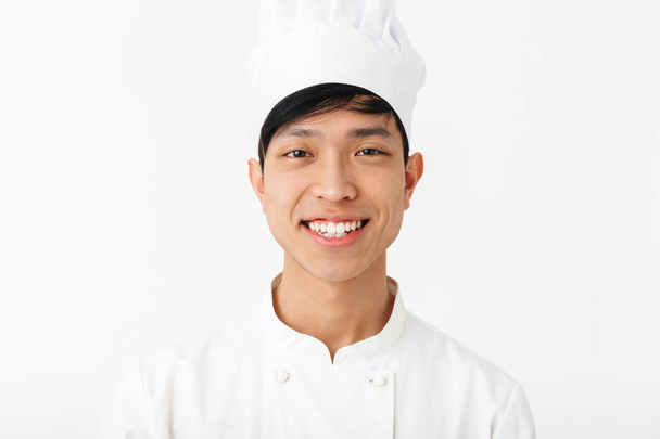 Excited asian chef wearing uniform standing - Foto, afbeelding