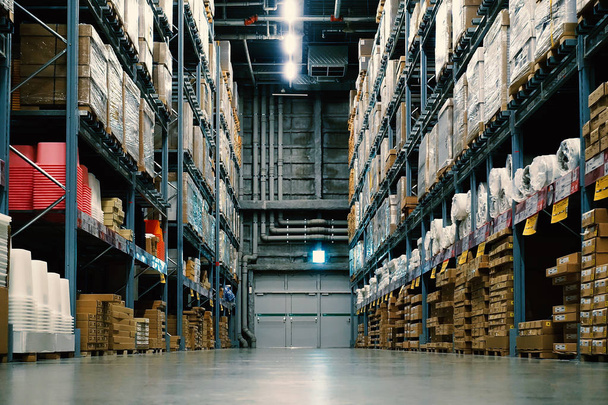 Large wharehouse with rows of shelves and goods boxes. - Photo, Image