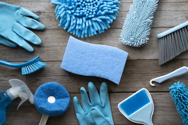 House cleaning product on wood table, blue equipment concept - Foto, afbeelding