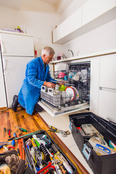 Workman repair dishwasher machine - Photo, Image