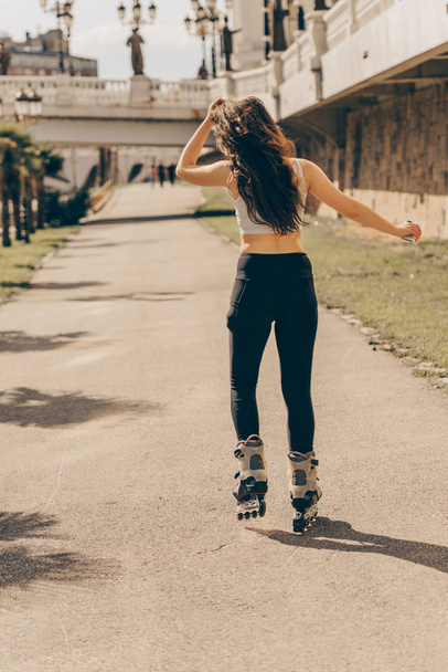 Sporty girl roller skating - Foto, Imagem