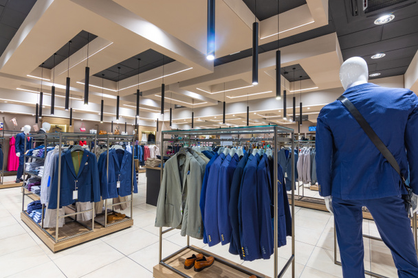 Internal view of a fashion store with generic jackets, mannequins, jeans and clothes. - Photo, Image