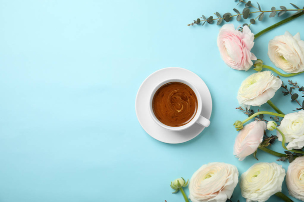 Flat lay composition with spring ranunculus flowers and cup of coffee on color background. Space for text - Zdjęcie, obraz