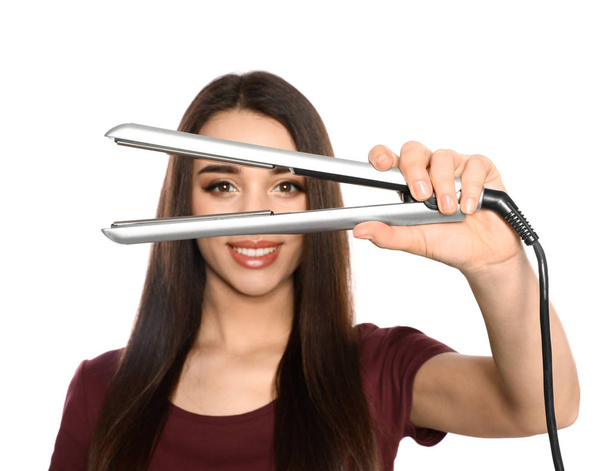 Happy woman with hair iron on white background - Photo, Image