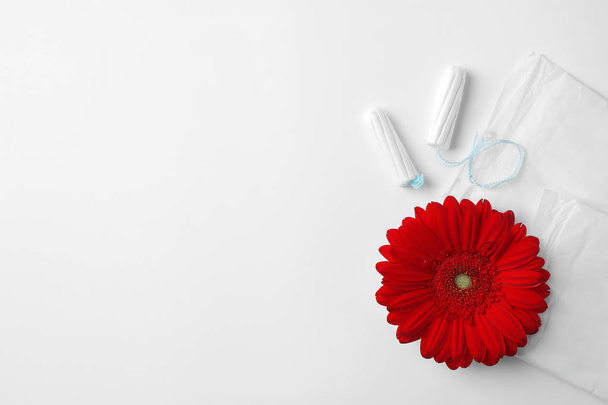 Different feminine hygiene products and flower on white background, top view with space for text. Gynecological care - Foto, Imagem