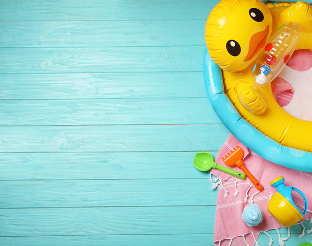 Flat lay composition with beach toys on color wooden background. Space for text - 写真・画像