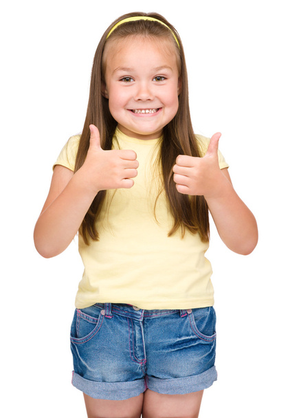маленька дівчинка показує великий палець вгору жест
 - Фото, зображення